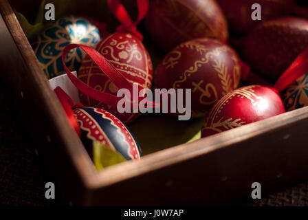 colorful handmade Easter eggs in wooden box Stock Photo