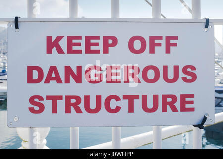 Colour image of a sign saying Keep Off Dangerous Structure at a harbour. Stock Photo