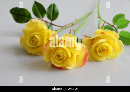 Wonderful clay art with yellow roses flower reflect on white background, beautiful artificial flowers of craftsmanship with skillful Stock Photo