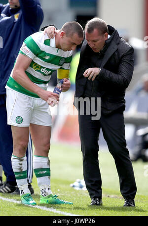 Celtic's Scott Brown and manager Brendan Rodgers (right) during the Ladbrokes Scottish Premiership match at the Global Energy Stadium, Dingwall. Stock Photo