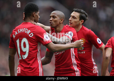 Manchester United's Marcus Rashford (left) celebrates scoring his side's first goal of the game with Manchester United's Ashley Young and Manchester United's Matteo Darmian during the Premier League match at Old Trafford, Manchester. Stock Photo