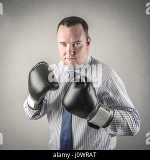 Businessman in boxing gloves Stock Photo