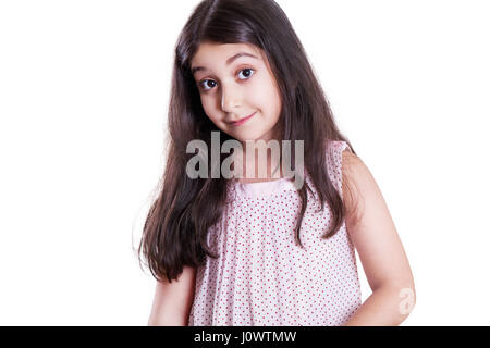 Beautiful happy little girl with long dark hair and dress looking at camera. studio shot, isolated on white background. Stock Photo