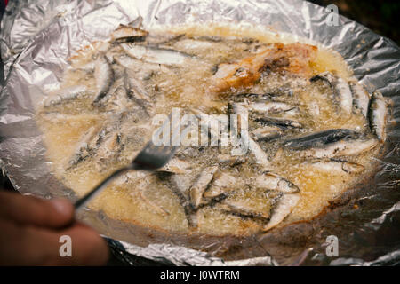 frying small fish in oil, close up Stock Photo