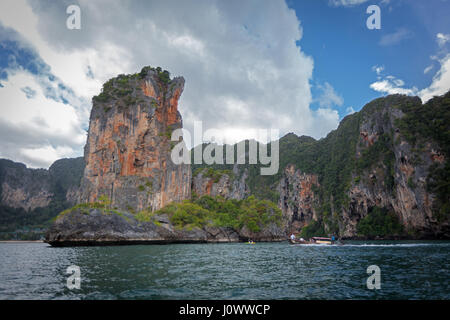 A long tail boat is heading back to Ao Nang from Railay Beach, Krabi Province, Thailand, Southeast Asia Stock Photo