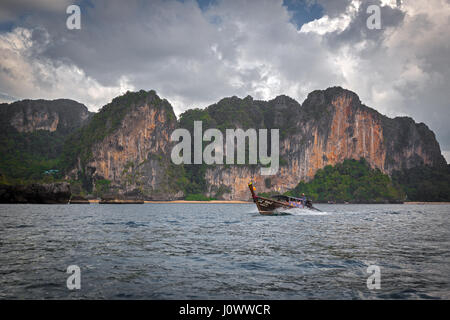 A long tail boat is heading back to Ao Nang from Railay Beach, Krabi Province, Thailand, Southeast Asia Stock Photo