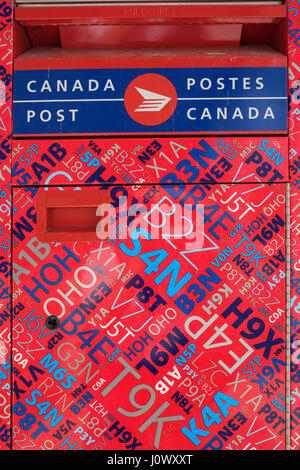 Canadian mailbox, modern design, Canada Post free-standing post box decorated with colourful postal codes. Stock Photo