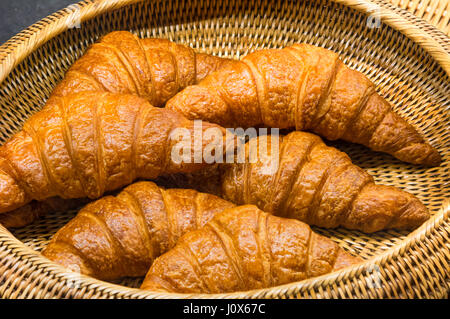 delicious croissants in a straw basket Stock Photo