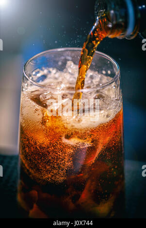 Expert barman is making cocktail at night club. Stock Photo