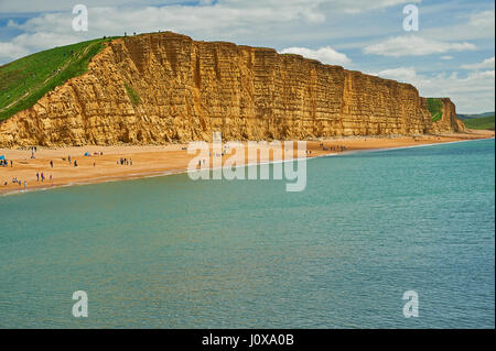 Sandstone cliffs of East cliff at the Dorset seaside town of West Bay. The iconic cliffs are on the Jurassic Coast and are some 150 million years old. Stock Photo