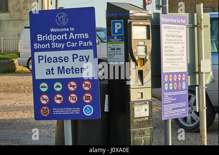 .Pay and Display car parking sign and ticket machine in West Bay, Dorset Stock Photo