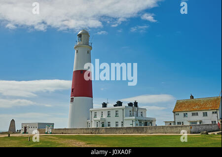The red and white tower of Portland light house, on the southern end of Portland Bill against a blue sky. Stock Photo