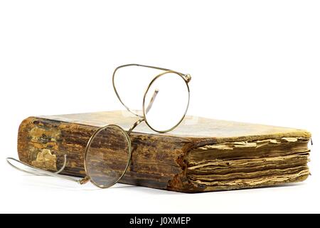 antique book with glasses isolated on white background Stock Photo