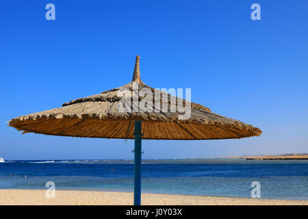 Egyptian parasol on the beach of Red Sea. Port Ghalib, Egypt. Stock Photo