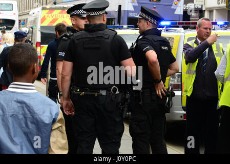 Armed police who were on routine patrol in Glasgow attend a road traffic incident in the city's Argyle Street during the Commonwealth Games Stock Photo