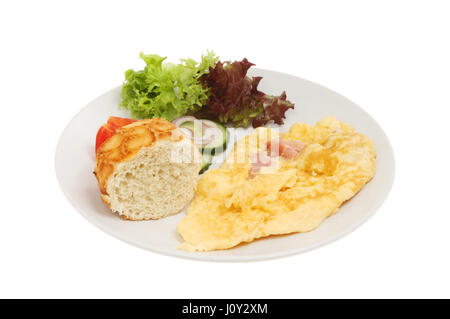 Cheese and ham omelet with salad and crusty bread on a plate isolated against white Stock Photo