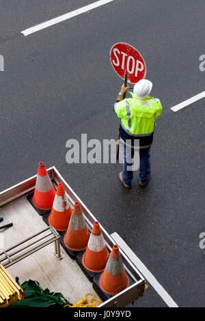 Road worker directing traffic at a road work site. Stock Photo