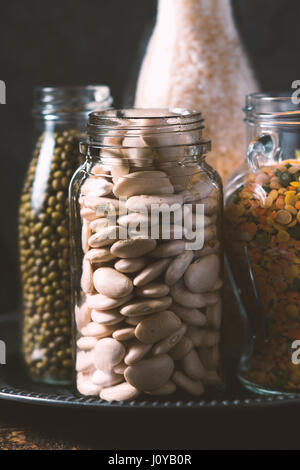 Rice, lentils, white beans in bottles side view vertical Stock Photo