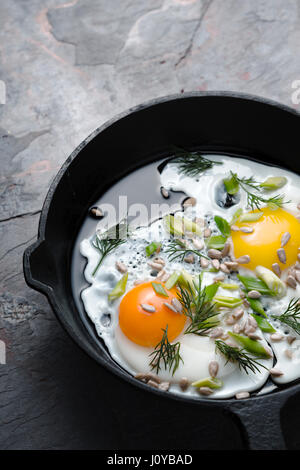 Scrambled eggs  on the dark stone background vertical Stock Photo