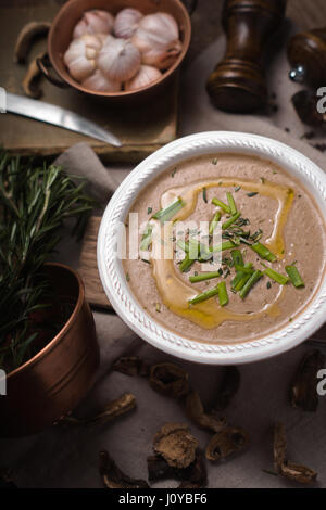 Mushroom cream soup on the wooden background vertical Stock Photo