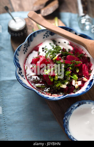 Traditional Russian and Ukrainian beetroot soup borsch with sour cream  greens vertical Stock Photo