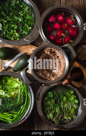 Ingredients for healthy salad with buckwheat ,vegetable and greens vertical Stock Photo