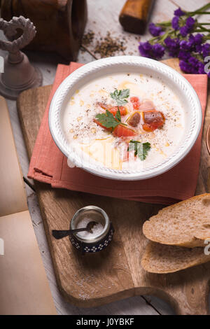 Soup puree with salmon in a ceramic bowl Stock Photo