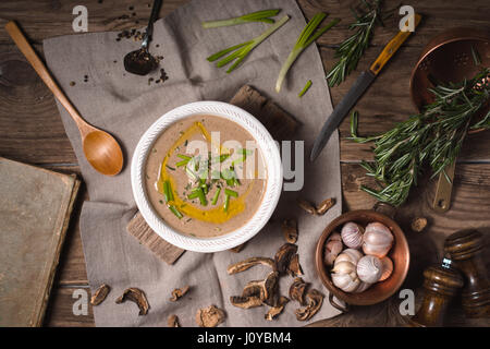 Mushroom cream soup on rustic background, top view Stock Photo