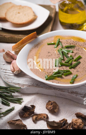 Mushroom soup puree in a ceramic bowl and olive oil Stock Photo