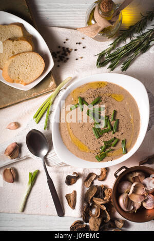 Mushroom soup puree in a ceramic bowl, bread Stock Photo