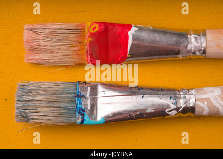 Brushes for drawing on a yellow table Stock Photo