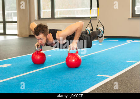 Active People Sport Workout Concept Man doing push-up exercise with dumbbell Stock Photo