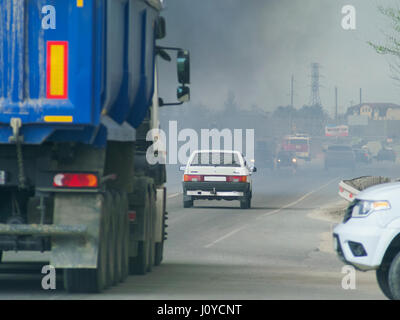 The cars in the smoke on the road Stock Photo