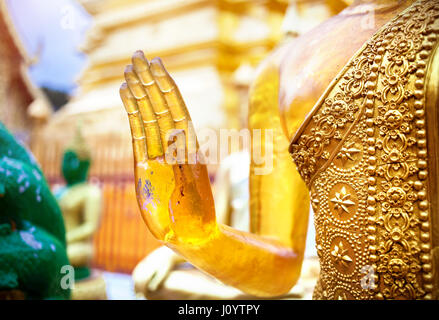 Hand of Buddha in mudra from yellow stone in Wat Doi Suthep, Ciang Mai, Thailand Stock Photo