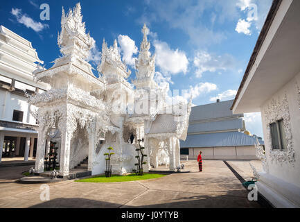 Woman in red costume in Wat Rong Khun The White Temple in Chiang Rai, Thailand Stock Photo