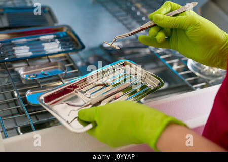 dentist hands holding dental instruments Stock Photo