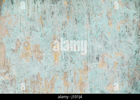 Weathered, faded and peeled off turquoise concrete wall texture background. Stock Photo