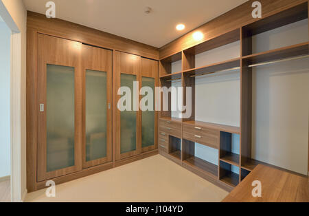 wooden carbinets in dressing room in modern home, interior design Stock Photo