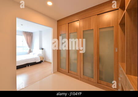 wooden carbinets in dressing room in modern home, interior design Stock Photo