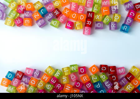 Many colorful decorative cubes with letters on a white background. Stock Photo