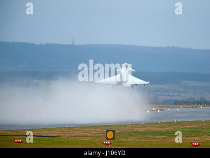 Eurofighter Typhoon taking off from a wet RAF Lossiemouth runway in Morayshire, Scotland. Stock Photo