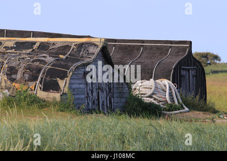 Upturned herring boats now used as storage sheds, Holy Island Stock Photo