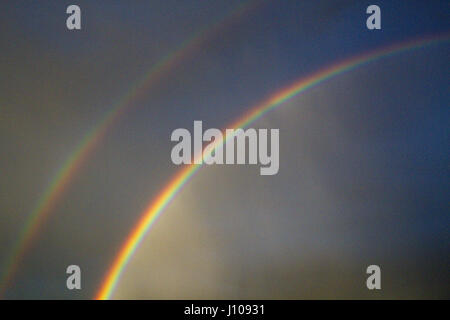 Natural, double rainbow graces a stormy sky in Tucson, Arizona. Stock Photo