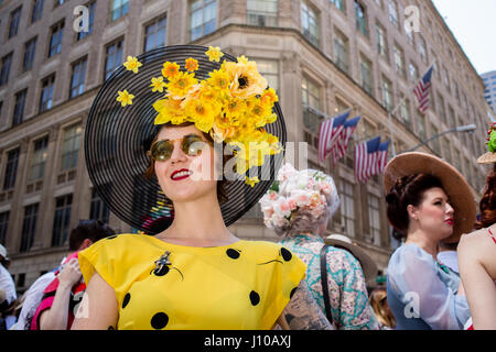 New York, USA. 16th Apr, 2017. A woman in a bright yellow dress wears a black straw hat decorated with yellow flowers under the brim at New York's annual Easter Bonnet Parade and Festival on Fifth Avenue. Credit: Ed Lefkowicz/Ģ����ý Live News Stock Photo