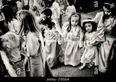 April 14, 2017 - Bossost, Lleida, Spain - Children dressed as angels take part to the Good Friday procession  by the streets of the Pyrenean village of Bossost. The town of Bossost, located in the north of the Pyrenees mountains  at the administrative entity of Val d'Aran, is a small village of 1000 inhabitants that since 1879 carries out the procession of Good Friday during the holy week. It is the only village in the area that has maintained this tradition and during this day the majority of its inhabitants dress as penitents to take to the streets in procession of Christian roots. (Credit I Stock Photo