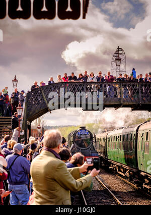 Trains on tracks, spectators on platform watch Stock Photo - Alamy