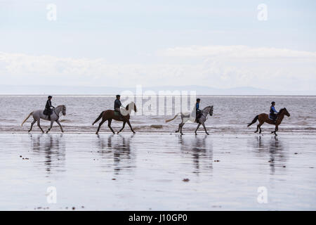 Porthcawl, South Wales, UK. 17th April, 2017. People enjoyed the long beach that stretches between Porthcawl and Ogmore by Sea in South Wales, today 17th April 2017. A dry but cloudy day didn't stop dog walkers, horse riders and families from enjoying the stretch of sand. Credit: Chris Stevenson/Alamy Live News Stock Photo