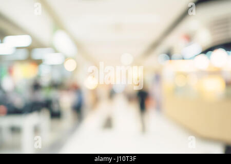 Defocused blur background. People shopping in department store. Stock Photo