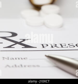 Pen and some pills over medical prescription form - close up studio shot Stock Photo