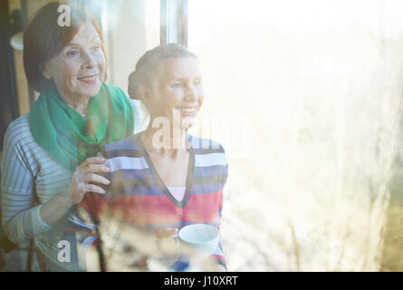 Two aged women enjoying warm spring day in cafe Stock Photo